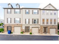 Attractive townhome featuring a neutral exterior with stone accents, well-kept lawns, and private garage at 992 Burning Bush Pt, Monument, CO 80132
