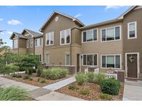Charming townhome with tidy landscaping, inviting entry, and neutral color palette at 15476 W 64Th Loop # C, Arvada, CO 80007
