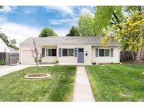 Charming ranch-style home with well-manicured lawn, inviting walkway, and beautiful curb appeal at 2986 S Elm St, Denver, CO 80222