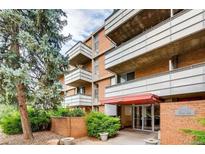 Brick condo building featuring multiple balconies and well-maintained landscaping at 2500 S York St # 401, Denver, CO 80210