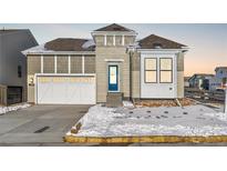 Craftsman style home with white garage door and blue front door at 9688 Winterset Cir, Littleton, CO 80125