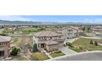 Beautiful two-story home featuring a meticulously landscaped yard and mountain views at 10597 Soulmark Way, Highlands Ranch, CO 80126