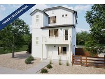 Two-story modern farmhouse-style home with a balcony and fenced yard at 13545 E 103Rd Ave, Commerce City, CO 80022