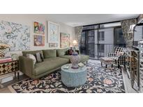Comfortable living room featuring an L-shaped sofa, patterned rug and eclectic decor at 2 Adams St # 809, Denver, CO 80206
