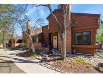 Charming townhome with brick chimney and manicured front yard with rock landscaping at 2685 S Dayton Way # 253, Denver, CO 80231