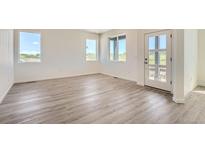 Bright living room boasting of luxury vinyl plank flooring, natural light and modern finishes at 1280 S Algonquian St, Aurora, CO 80018