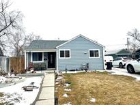 Charming one-story home with blue siding, a cozy front porch, and a well-maintained lawn at 1641 S Zenobia St, Denver, CO 80219