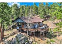 Beautiful home with mature trees and a large deck, perfect for outdoor entertaining and enjoying nature at 28669 Mountain View Rd, Conifer, CO 80433