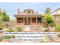 Charming brick home featuring a manicured front yard and inviting covered porch perfect for relaxation at 2845 Quitman St, Denver, CO 80212