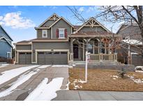 Charming two-story home with three-car garage and covered front porch at 9976 Pitkin St, Commerce City, CO 80022