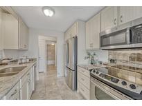 Well-lit kitchen featuring stainless steel appliances and contrasting countertops at 4800 E Hale Pkwy # 802N, Denver, CO 80220