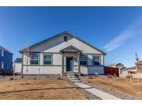 Craftsman style home with gray accents and a landscaped front yard at 2937 Pershing St, Strasburg, CO 80136