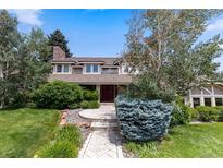 Charming two-story home with mature landscaping and a welcoming front entrance at 7750 S Glencoe Way, Centennial, CO 80122