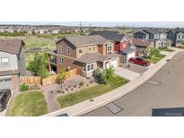 Beautiful two-story home featuring a manicured lawn, charming architectural details, and inviting curb appeal at 4781 Basalt Ridge Cir, Castle Rock, CO 80108
