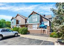 Attractive townhouse with mixed siding, manicured bushes and a convenient parking area at 13271 Holly St # B, Thornton, CO 80241