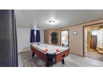 Basement game room with air hockey table and bathroom at 1242 Elder St, Denver, CO 80221