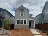 Charming two-story home with a combination brick and siding exterior and a well-maintained front yard at 2079 Generations Aly, Brighton, CO 80601