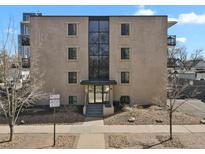 Three-story building with a modern glass-covered entryway and a professionally landscaped front at 100 S Clarkson St # 202, Denver, CO 80209