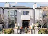 Stunning contemporary home with a black front door and manicured landscaping at 335 Clayton St, Denver, CO 80206