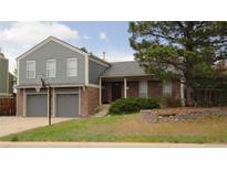 Charming two-story home featuring a two-car garage and a basketball hoop in the driveway at 6815 Hills Dr, Parker, CO 80138