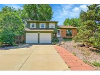 Charming two-story home with a two car garage, well-manicured lawn and mature trees at 2211 Sherman St, Longmont, CO 80501