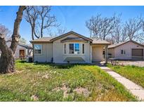 Charming single-story home with a bay window and well-maintained lawn at 4740 Milwaukee St, Denver, CO 80216