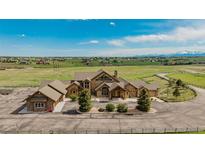 Beautiful stone home with a circular driveway situated on a spacious lot with mountain views at 15958 Shadow Mountain Ranch Rd, Larkspur, CO 80118