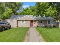 Charming single-story home featuring a well-maintained lawn, inviting walkway, and mature trees at 3278 S Forest St, Denver, CO 80222