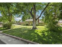 Charming green home with large front yard and mature shade trees at 1975 Cody St, Lakewood, CO 80215