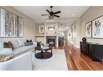 Inviting living room features a fireplace, hardwood floors, and a modern ceiling fan at 3734 Ridgeway St, Boulder, CO 80301
