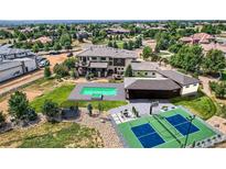 Expansive home boasts a pool, tennis court, trampoline, and lush landscaping in a desirable neighborhood at 2635 Spruce Meadows Dr, Broomfield, CO 80023