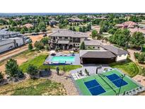 Expansive backyard featuring a pool, sport court, trampoline, and outdoor seating area at 2635 Spruce Meadows Dr, Broomfield, CO 80023