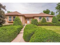Charming single-Gathering home boasts a well-manicured lawn and mature landscaping at 4162 S Dunkirk Way, Aurora, CO 80013