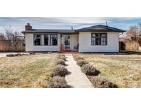 Charming single-story home with a well-maintained front yard and inviting entrance pathway at 835 Lewis Dr, Lakewood, CO 80215