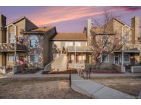 Inviting multi-level townhome with a manicured lawn and cozy front patio, perfect for relaxing outdoors at 1079 S Walden Way # 217, Aurora, CO 80017