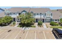 Two-story townhouses with gray roofs and light blue siding, ample parking at 5895 Biscay St # D, Denver, CO 80249