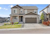 Charming two-story home featuring a two-car garage, well-maintained lawn, and inviting front porch with white railings at 2576 Villageview Ln, Castle Rock, CO 80104