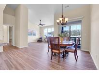 An open-concept living room features wood floors and a dining area with scenic views at 1194 Red Lodge Dr # 201, Evergreen, CO 80439