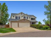 Charming two-story home featuring a three-car garage, well-maintained lawn, and beautiful landscaping at 5302 S Robb Ct, Littleton, CO 80127