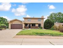Charming two-story home with a well-manicured lawn and inviting curb appeal at 8588 E Costilla Ave, Centennial, CO 80112