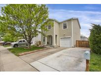 Charming two-story home with a well-manicured lawn and a mature shade tree at 1341 Kingfisher Ave, Brighton, CO 80601