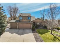 Two story home with a three car garage, covered porch, and nice landscaping at 545 Saber Creek Dr, Monument, CO 80132