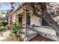 Charming front porch with decorative iron railings and ample seating space at 3953 Tejon St, Denver, CO 80211