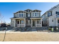 Charming townhome showcases a well-maintained front yard, complementing its appealing two-story facade at 1244 Penner Dr, Erie, CO 80026