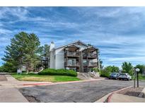 Exterior view of a multi-story condo with balconies and well-maintained landscaping at 17595 E Mansfield Ave # 1331L, Aurora, CO 80013