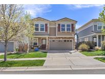 Two-story home showcasing great curb appeal, a two-car garage, and manicured lawn at 2410 Morningview Ln, Castle Rock, CO 80109