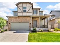 Charming two-story home showcasing a stone facade, a two-car garage, and a welcoming front porch with a manicured lawn at 6591 N Ceylon St, Denver, CO 80249