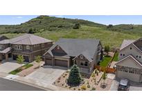 Charming two-story home with a landscaped front yard and a three-car garage, perfect for families at 1815 Avery Way, Castle Rock, CO 80109