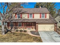 Charming two-story home with red shutters, brick accents, and a well-manicured front yard at 6363 E Jamison S Cir, Centennial, CO 80112