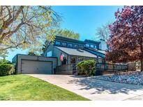 Charming home featuring a modern design, attached garage, and a well-maintained lawn, perfect for suburban living at 8277 Carriage Ln, Parker, CO 80134